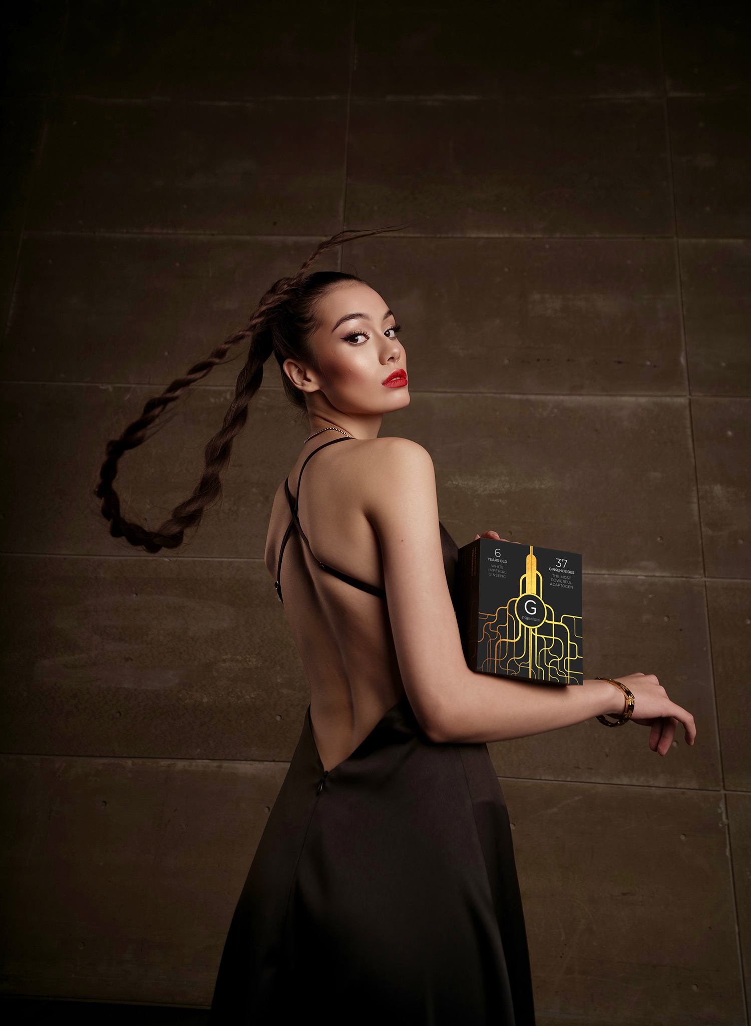 A woman is standing with a G PREMIUM box