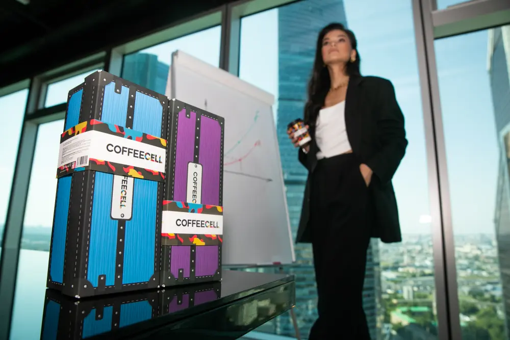 The COFFEECELL boxes are opposite the girl with a cup