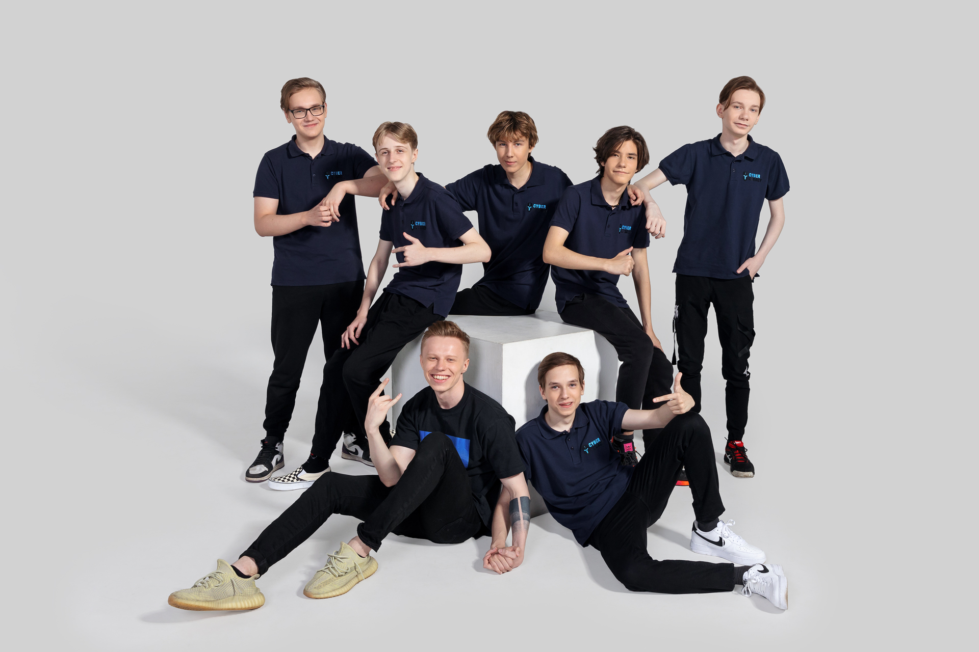 Cyber Legacy Team standing and sitting on a cube