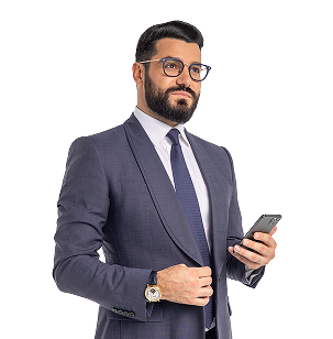 Narek in a suit with a phone