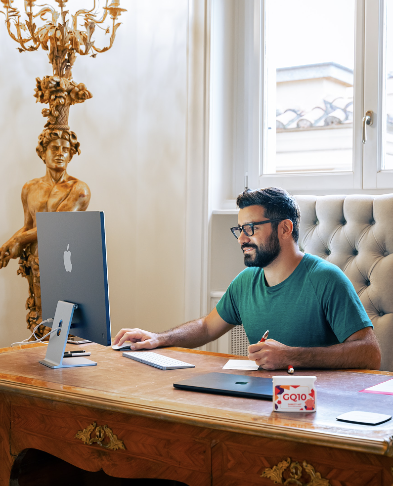 Narek in a teal t-shirt at the computer