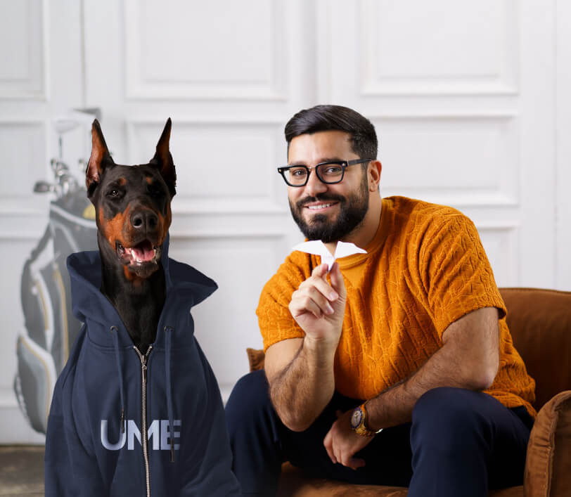 Narek with a Doberman in an UME hoodie