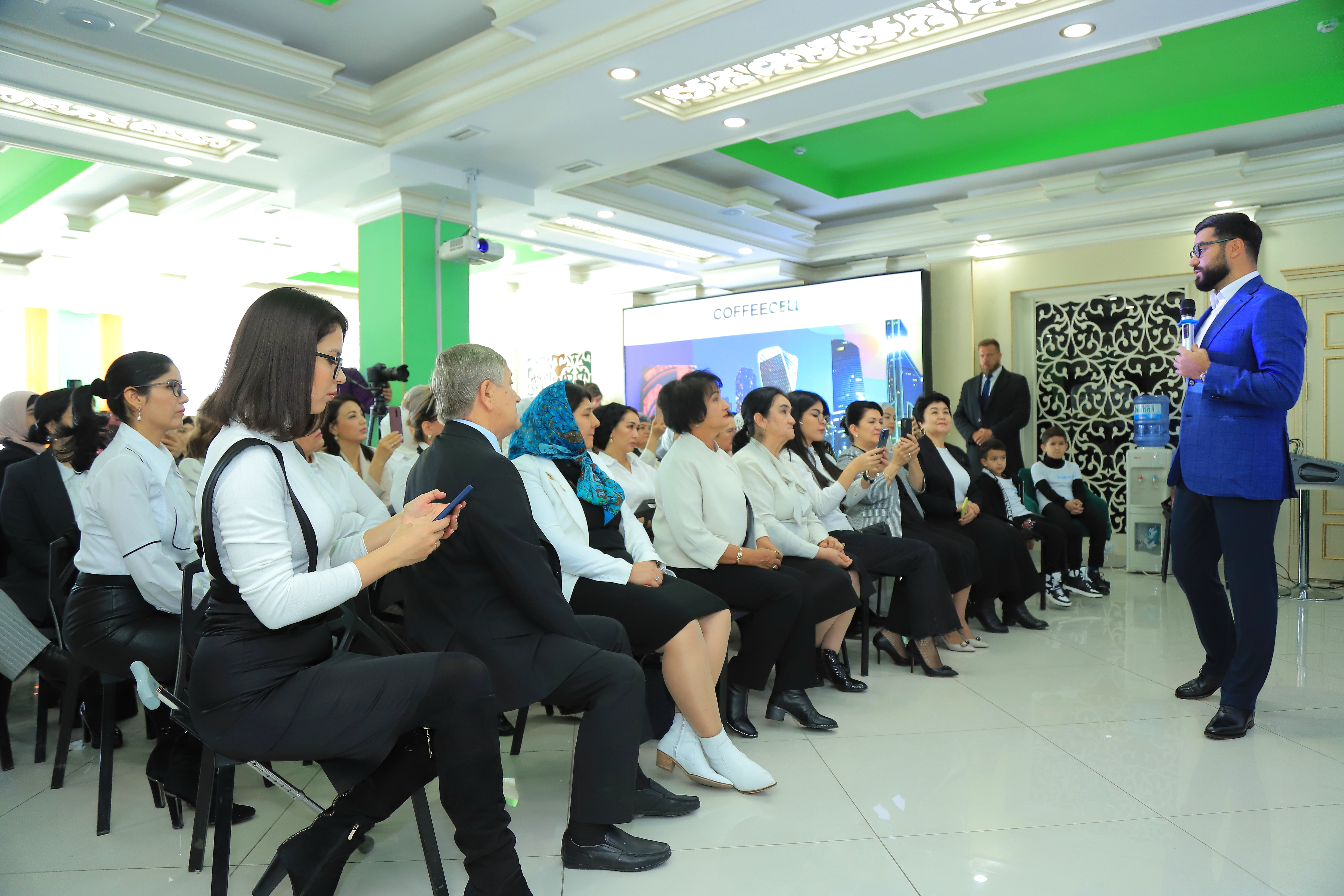 Narek with a microphone at the opening of Project V and COFFEECELL