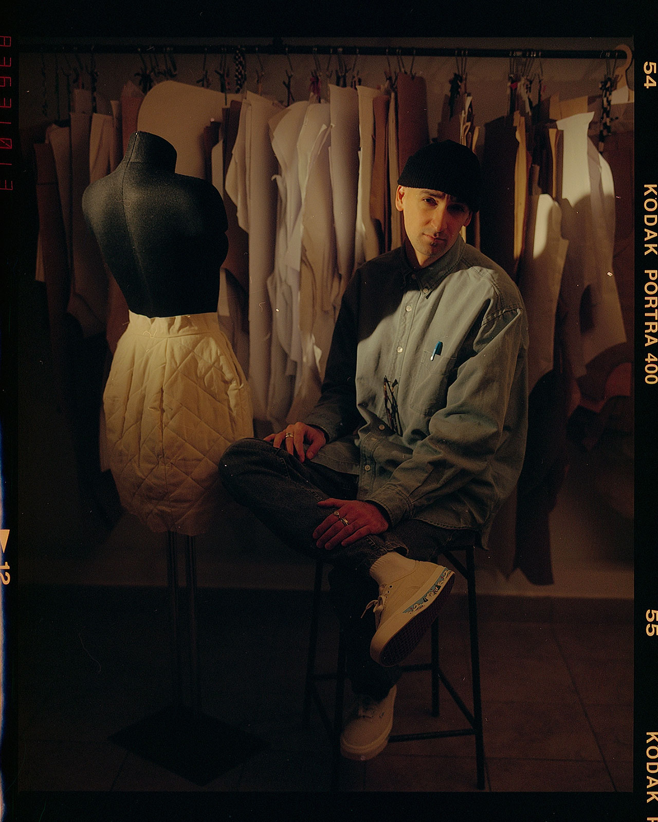 Eric Ambar is sitting with a mannequin