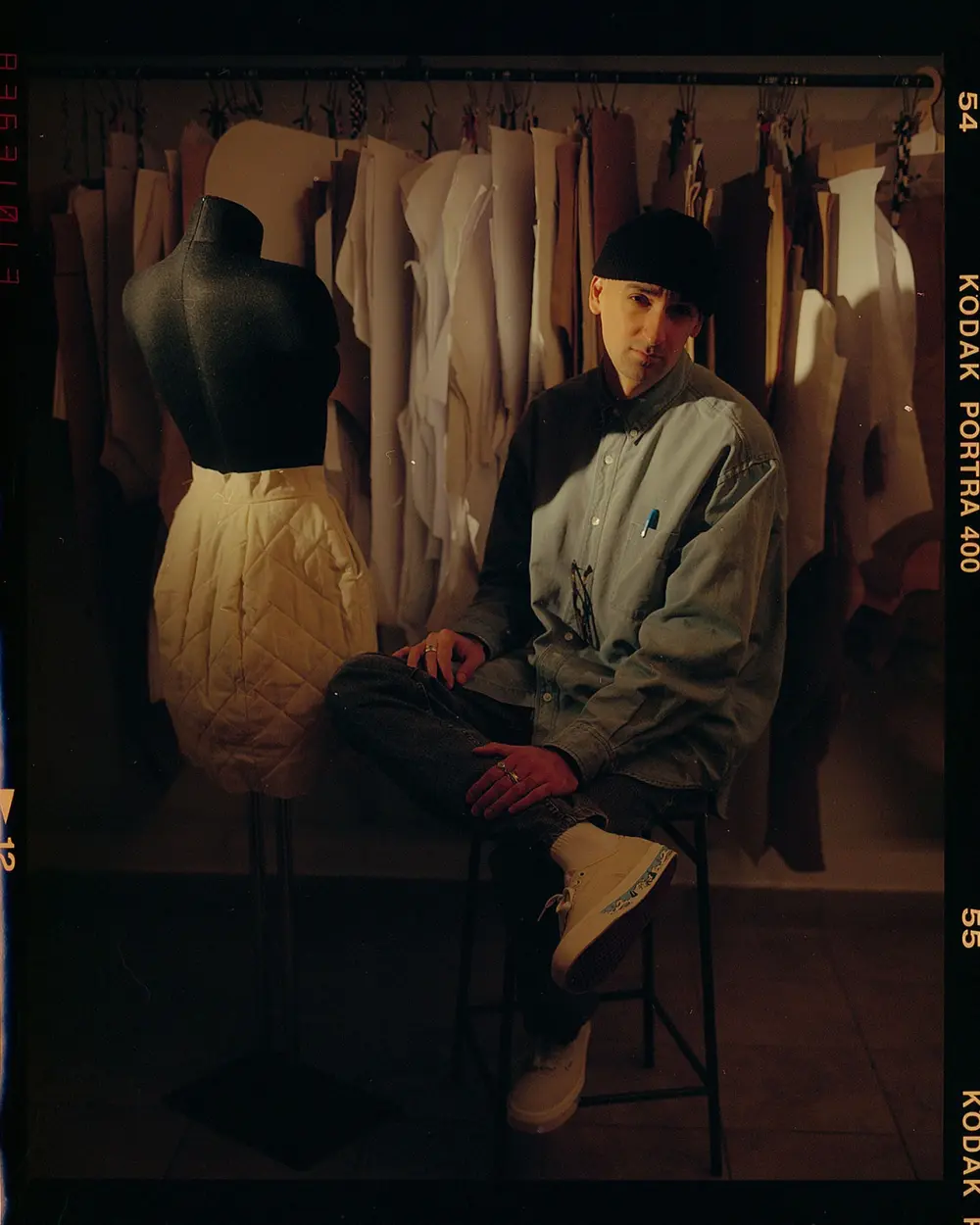 Eric Ambar is sitting with a mannequin