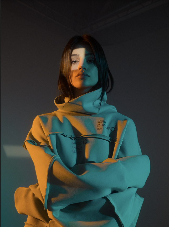 Woman in an oversized NRK87 hoodie