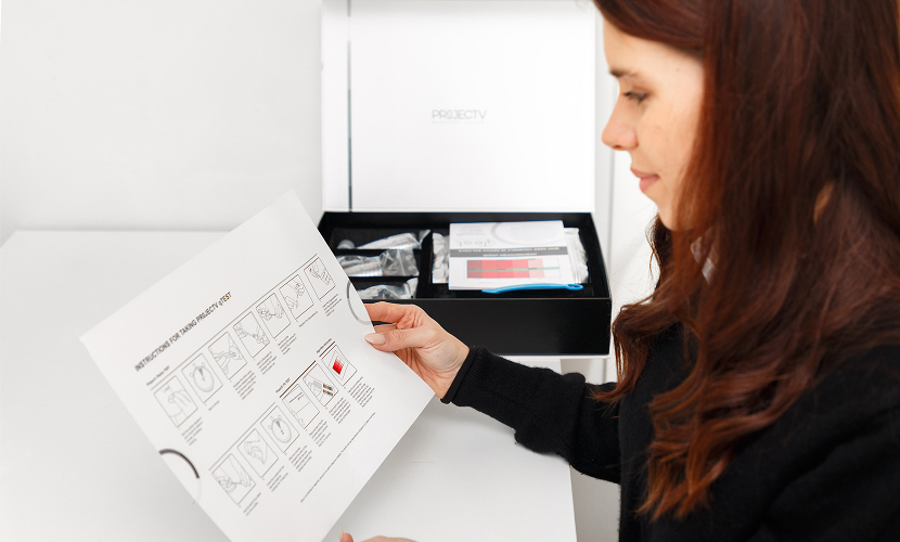 Woman reading the qTest instruction