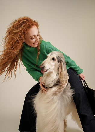 Woman behind a hairy dog